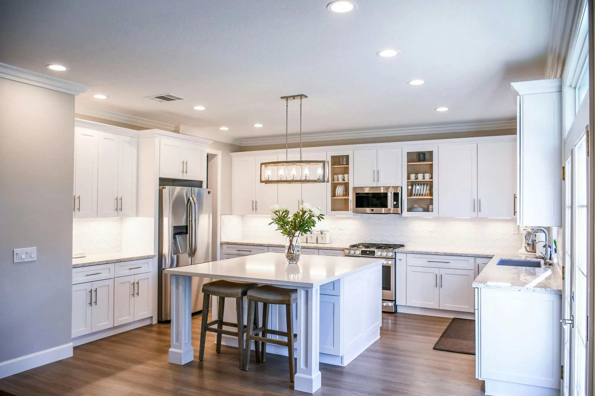 Remodeled kitchen with white cabinetry and island